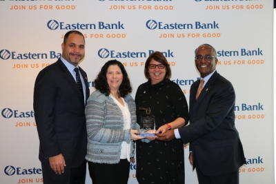Gina Scaramella accepts award from Eastern Bank staffers
