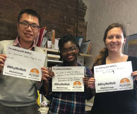 Three BARCC interns holding up signs about why they walk for change 